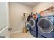 Laundry room with washer, dryer, and ample storage space at 413 Kinross Ln, Peachtree City, GA 30269