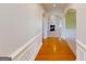 Hardwood floors in an entryway with views into the living room and fireplace at 6383 Edgewater Cv, Fairburn, GA 30213