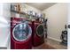 Laundry room with washer, dryer, and ample shelf space at 1145 Eagles Brooke Dr, Locust Grove, GA 30248