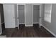 Spacious bedroom with two closets and dark flooring at 5274 Ridge Forest Dr, Stone Mountain, GA 30083