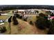 Aerial view of a property with a house, trees, and a nearby school at 5300 Salem Rd, Covington, GA 30016