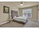 Well-lit bedroom featuring a tufted headboard, window, and carpeted floors at 12795 Wyngate, Alpharetta, GA 30005