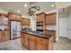 Kitchen featuring wood cabinets, a center island with a gas cooktop, and stainless steel appliances at 12795 Wyngate, Alpharetta, GA 30005