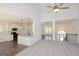 Open-concept kitchen and living area with white cabinetry and breakfast bar at 3278 Greenhill Dr, Villa Rica, GA 30180