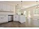 White kitchen with stainless steel appliances, granite countertops, and wood floors at 3278 Greenhill Dr, Villa Rica, GA 30180