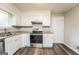 Updated kitchen featuring white cabinets, stainless steel appliances, and granite countertops at 6187 Deans Way, Morrow, GA 30260