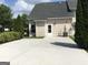 Private concrete backyard patio surrounded by greenery at 160 Orchard Dr, Covington, GA 30014