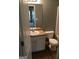 Bathroom with white vanity, toilet, and wood-look flooring at 160 Orchard Dr, Covington, GA 30014