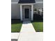 Welcoming front entry with white columns and black door at 160 Orchard Dr, Covington, GA 30014