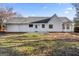 Back view of a house with a backyard and trees at 215 Woodfield Ct, Mcdonough, GA 30253