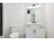 Bathroom vanity featuring a white countertop, shaker cabinets, black hardware, and a large mirror at 3920 Clifton Hill Ct, Cumming, GA 30040