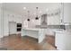 Bright, open kitchen boasts a large island, stainless steel appliances, and elegant white cabinetry at 3920 Clifton Hill Ct, Cumming, GA 30040
