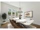 Bright dining room with a marble top table and large windows at 3920 Clifton Hill Ct, Cumming, GA 30040