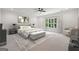 Bedroom with a neutral color palette, soft lighting and a plush bed and sitting area at 3920 Clifton Hill Ct, Cumming, GA 30040