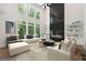 Bright living room with tall windows, fireplace, and plush seating arrangement at 3920 Clifton Hill Ct, Cumming, GA 30040