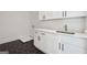 Clean and modern laundry room features stylish cabinetry, countertops, and hexagonal tile flooring at 3920 Clifton Hill Ct, Cumming, GA 30040