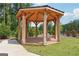 A beautiful natural wood gazebo surrounded by landscaping, providing a relaxing outdoor space at 3920 Clifton Hill Ct, Cumming, GA 30040