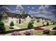 Street view of newly constructed modern homes with lush landscaping and paved road at 3920 Clifton Hill Ct, Cumming, GA 30040