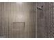 Modern shower with dark herringbone tile, built-in niche, and a rainfall shower head at 3920 Clifton Hill Ct, Cumming, GA 30040