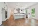 Spacious kitchen includes stainless steel appliances, large island, and access to outdoor deck at 3920 Clifton Hill Ct, Cumming, GA 30040