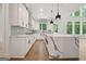 Well-lit kitchen with stainless steel appliances, quartz countertops, large windows, and a kitchen island at 3920 Clifton Hill Ct, Cumming, GA 30040