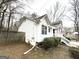 Side view of a two-story home with white siding, a fenced yard, and shrubs at 4050 Sumit Wood Dr, Kennesaw, GA 30152