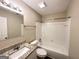 Bathroom with granite countertop, white tile shower/tub combo, and updated fixtures at 1091 Cherry Laurel Dr, Lithonia, GA 30058
