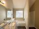 Clean bathroom featuring granite countertop, white vanity, and a bathtub at 1091 Cherry Laurel Dr, Lithonia, GA 30058