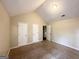 Spacious bedroom with vaulted ceiling, plush carpet, and multiple closets at 1091 Cherry Laurel Dr, Lithonia, GA 30058