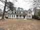 Two-story home with covered front porch and autumn leaves on the lawn at 1091 Cherry Laurel Dr, Lithonia, GA 30058