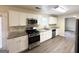 Updated kitchen featuring white shaker cabinets, stainless steel appliances, and granite countertops at 1091 Cherry Laurel Dr, Lithonia, GA 30058