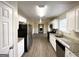 Modern kitchen with white cabinets, granite countertops, and stainless steel appliances at 1091 Cherry Laurel Dr, Lithonia, GA 30058