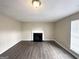 Living room with wood-look floors, fireplace, and neutral-toned walls at 1091 Cherry Laurel Dr, Lithonia, GA 30058