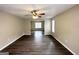 Spacious living room with dark wood-look flooring and ceiling fan at 1091 Cherry Laurel Dr, Lithonia, GA 30058