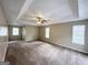 Large main bedroom with tray ceiling, ceiling fan, and multiple windows at 1091 Cherry Laurel Dr, Lithonia, GA 30058