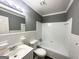 Bathroom with white tile walls, white fixtures, and a shower/tub combo at 3102 W Peek Nw Rd, Atlanta, GA 30318