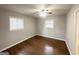 Bedroom with hardwood floors, ceiling fan, two windows, and neutral gray walls at 2830 Battle Forrest Dr, Decatur, GA 30034