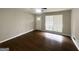 Bright living room featuring hardwood floors, large windows, and a ceiling fan at 2830 Battle Forrest Dr, Decatur, GA 30034