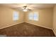 Spacious bedroom with plush carpeting, ceiling fan, and multiple windows at 1581 Mcclelland Ave, Atlanta, GA 30344