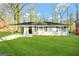 Single-story home with a lush green lawn and covered entrance at 1581 Mcclelland Ave, Atlanta, GA 30344