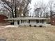 Charming single-story home with a gray brick exterior and autumn leaves at 1581 Mcclelland Ave, Atlanta, GA 30344