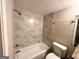 Modern bathroom with tiled shower surround, a pedestal sink, and updated fixtures at 2003 Rosewood Rd, Decatur, GA 30032