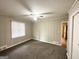Spacious bedroom with neutral walls, plush carpet, ceiling fan, and chair rail details at 2003 Rosewood Rd, Decatur, GA 30032