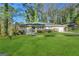 Charming ranch-style home with a lush green lawn and mature trees at 2003 Rosewood Rd, Decatur, GA 30032