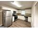 Bright kitchen featuring white shaker cabinets, stainless steel appliances, and wood-look flooring at 2003 Rosewood Rd, Decatur, GA 30032