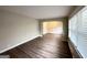 Empty living room with neutral walls, wood-look flooring, and an arched entryway at 2003 Rosewood Rd, Decatur, GA 30032