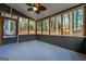 Large screened porch with outdoor ceiling fan and views of backyard trees at 138 Rockspray Ridge, Peachtree City, GA 30269