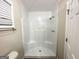 White tile shower and toilet in simple bathroom interior at 464 Stonewood Dr, Stone Mountain, GA 30087