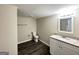 Modern bathroom with granite vanity, toilet, and wood-look tile flooring at 464 Stonewood Dr, Stone Mountain, GA 30087