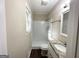 Clean bathroom featuring white tile, granite vanity top, and updated fixtures at 464 Stonewood Dr, Stone Mountain, GA 30087